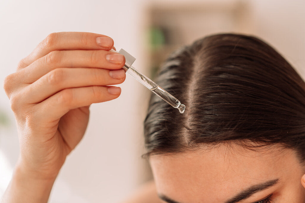lady dripping oil on her scalp